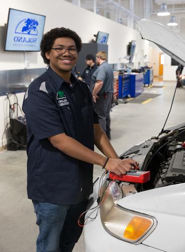 Student working a car engine